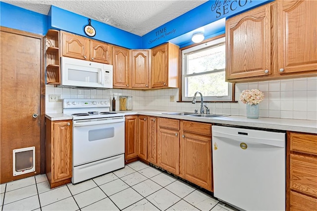 kitchen featuring light tile flooring, white appliances, tasteful backsplash, and sink