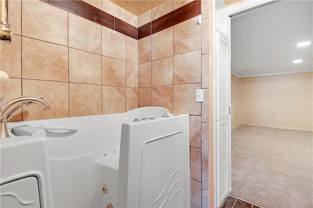 bathroom with tile walls, crown molding, and tile flooring