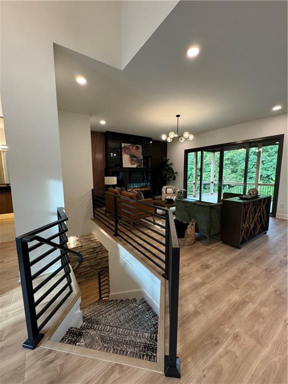 stairway featuring hardwood / wood-style floors and an inviting chandelier