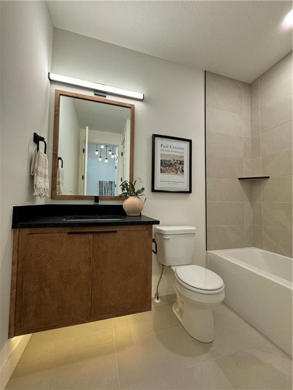 full bathroom with tile patterned floors, vanity, tiled shower / bath combo, and toilet