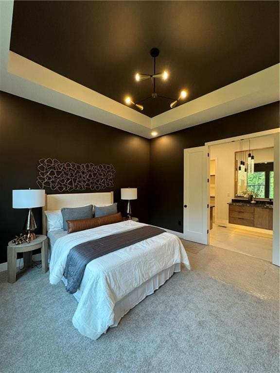 carpeted bedroom with a raised ceiling