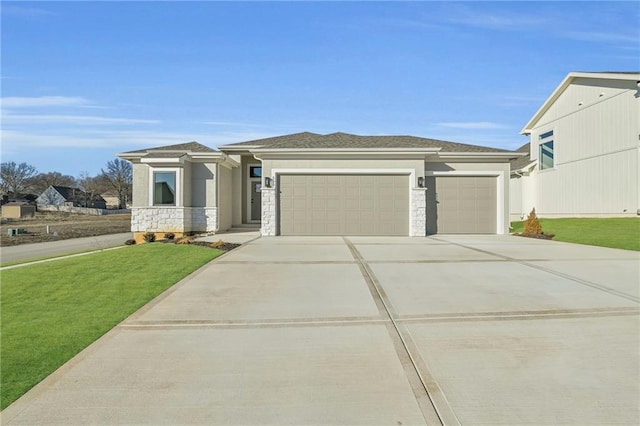 prairie-style home with a garage and a front lawn