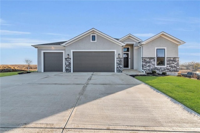 view of front of house featuring a garage and a front lawn