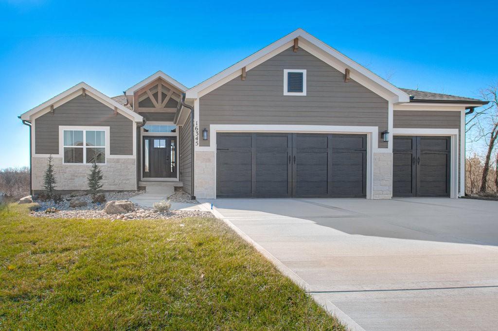 craftsman-style home with a garage and a front yard