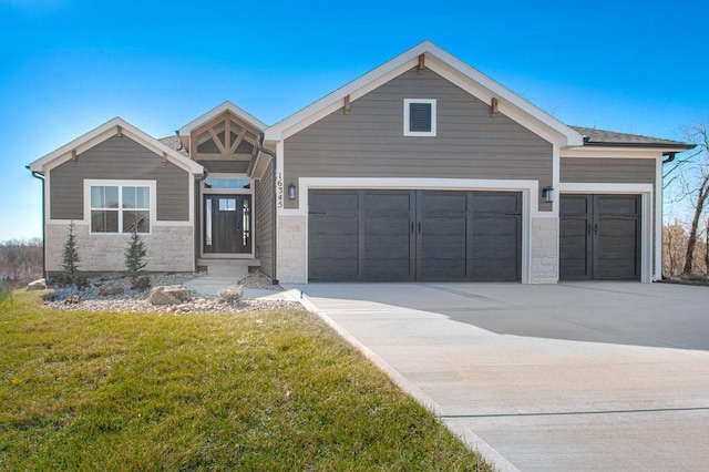 craftsman-style home with a garage and a front yard