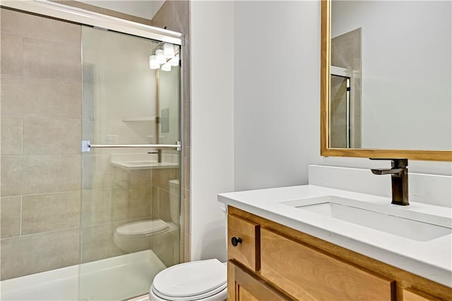 bathroom with vanity, toilet, and walk in shower