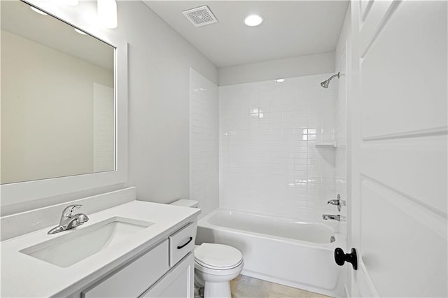 full bathroom with tiled shower / bath combo, vanity, and toilet