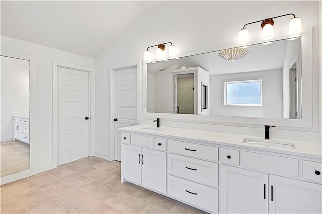 bathroom featuring lofted ceiling and vanity