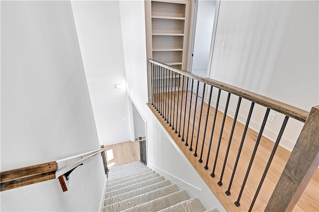 stairs with hardwood / wood-style flooring