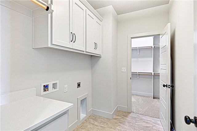 washroom with hookup for a washing machine, cabinets, and hookup for an electric dryer