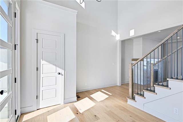 foyer featuring light hardwood / wood-style floors and a high ceiling