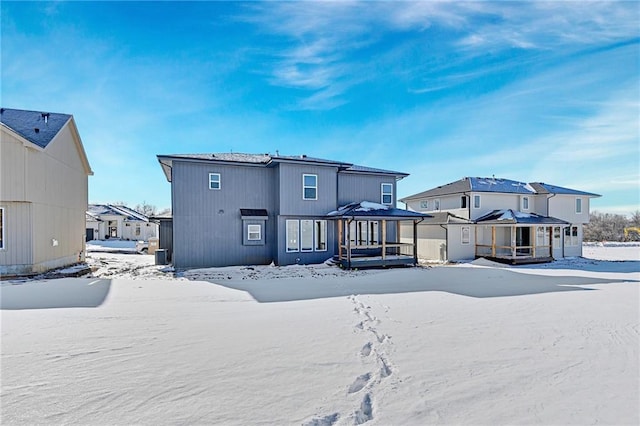 view of snow covered rear of property