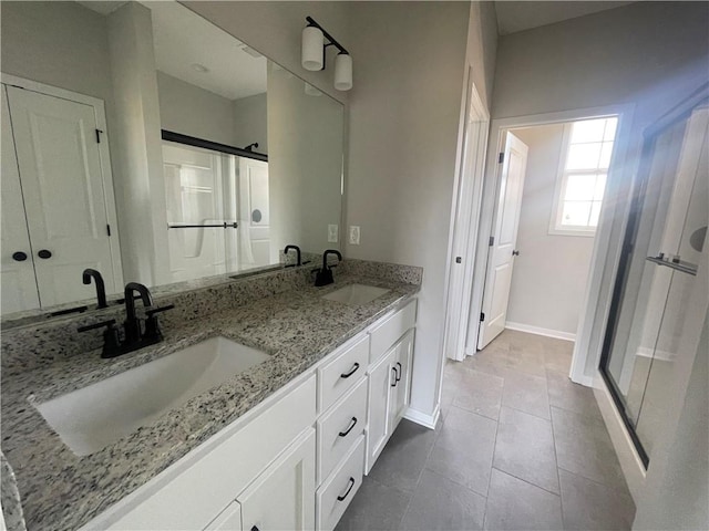 bathroom featuring walk in shower, vanity, and tile patterned flooring