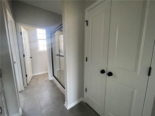 hall with light tile patterned floors