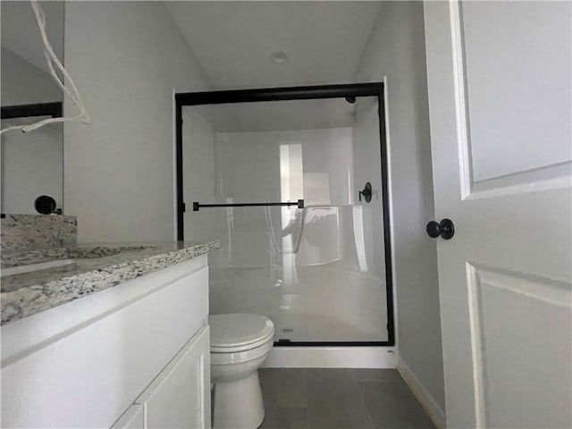 bathroom with vanity, toilet, and walk in shower