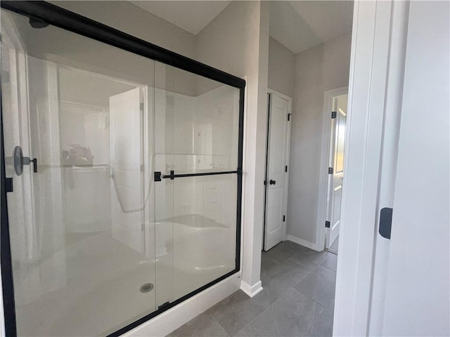 bathroom with a shower with shower door