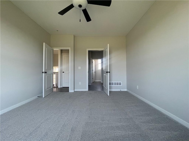 unfurnished bedroom featuring ceiling fan and carpet