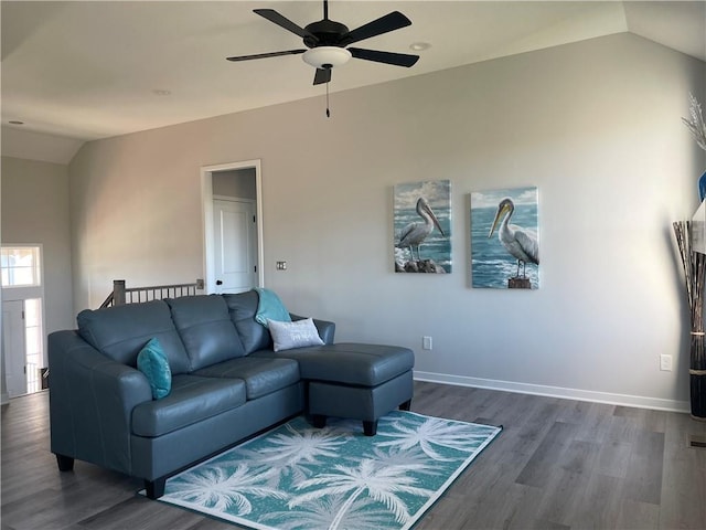 living room featuring dark wood-type flooring, vaulted ceiling, and ceiling fan