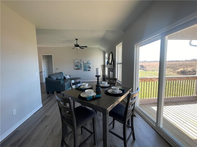 dining room with lofted ceiling, dark wood-type flooring, and ceiling fan