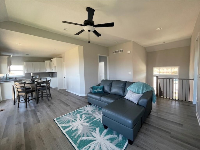 living room with ceiling fan, sink, vaulted ceiling, and hardwood / wood-style flooring