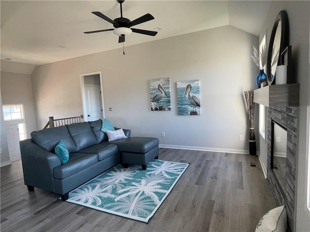 living room with dark wood-type flooring, vaulted ceiling, and ceiling fan