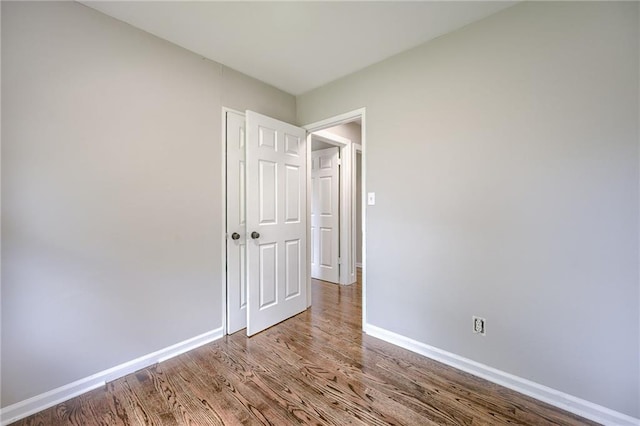 unfurnished room with hardwood / wood-style floors