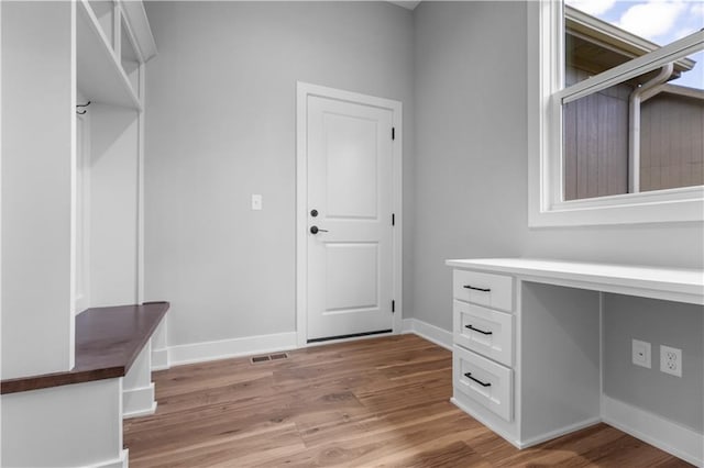 mudroom with light hardwood / wood-style floors