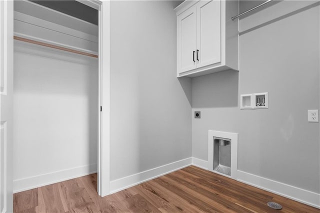 laundry room featuring hookup for an electric dryer, hookup for a washing machine, light wood-type flooring, and cabinets