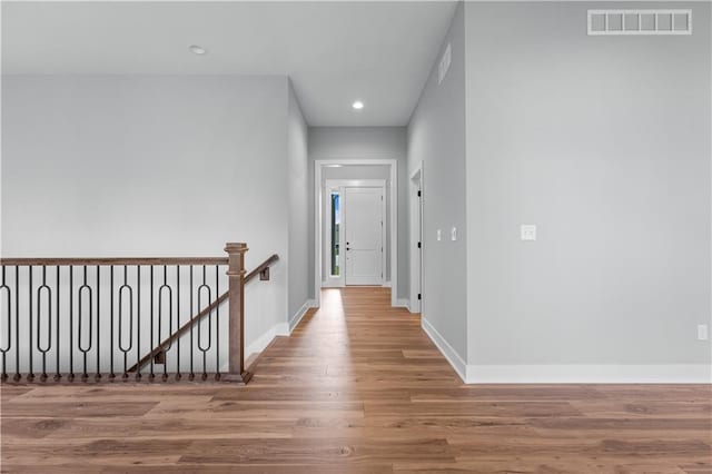 hall with hardwood / wood-style flooring