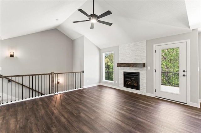 unfurnished living room with dark hardwood / wood-style floors, a healthy amount of sunlight, and lofted ceiling