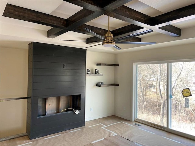 interior space featuring a fireplace, baseboards, coffered ceiling, and beamed ceiling