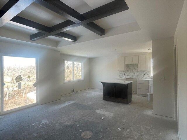 interior space featuring coffered ceiling and beam ceiling