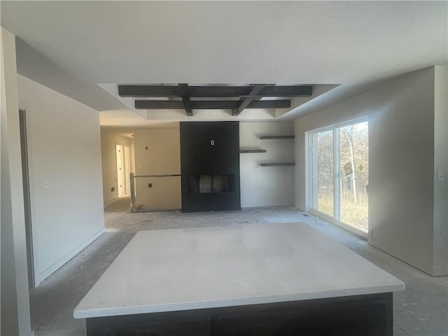 living area featuring coffered ceiling and beam ceiling