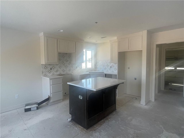 kitchen featuring backsplash, white cabinetry, and a center island