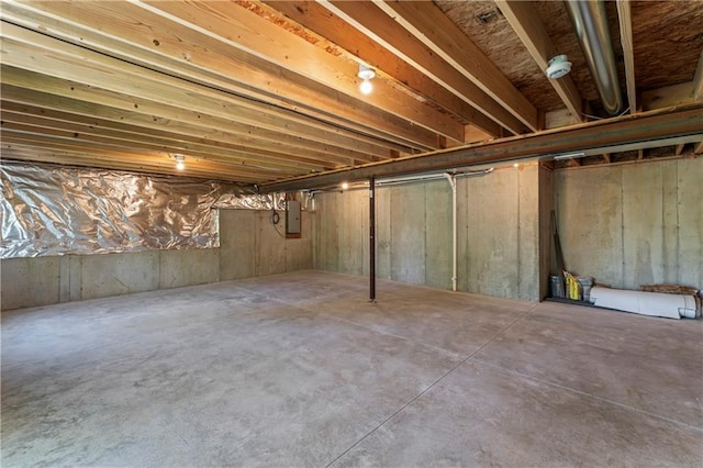 unfinished basement featuring electric panel