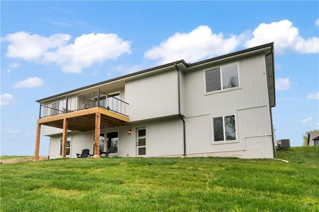 rear view of property featuring a deck, cooling unit, and a yard