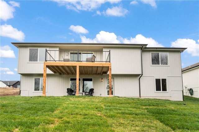 back of house with a deck and a yard