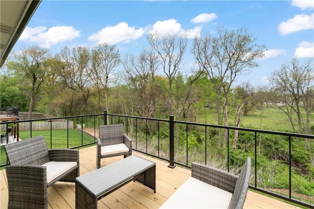wooden deck featuring a lawn