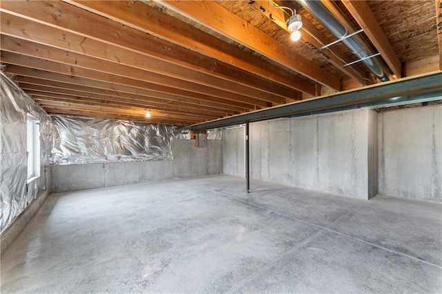 unfinished basement featuring electric panel