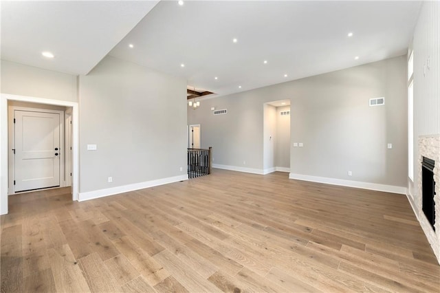 unfurnished living room featuring a fireplace, light wood finished floors, recessed lighting, visible vents, and baseboards