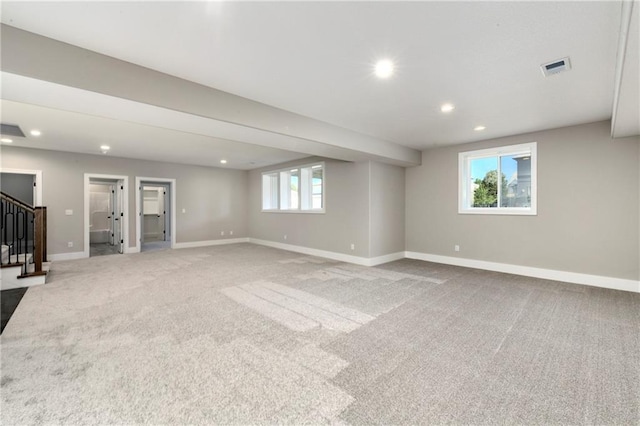 below grade area featuring carpet floors, stairs, baseboards, and recessed lighting