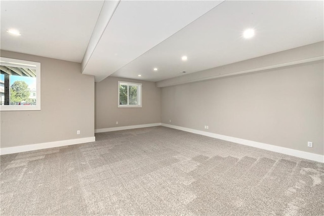 spare room featuring recessed lighting, baseboards, and light colored carpet