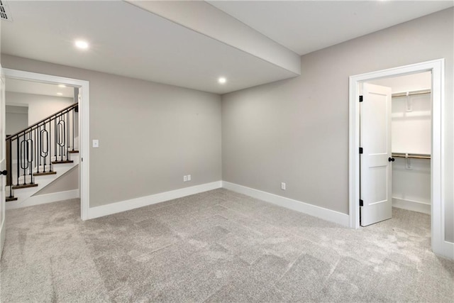 basement with recessed lighting, carpet flooring, baseboards, and stairs