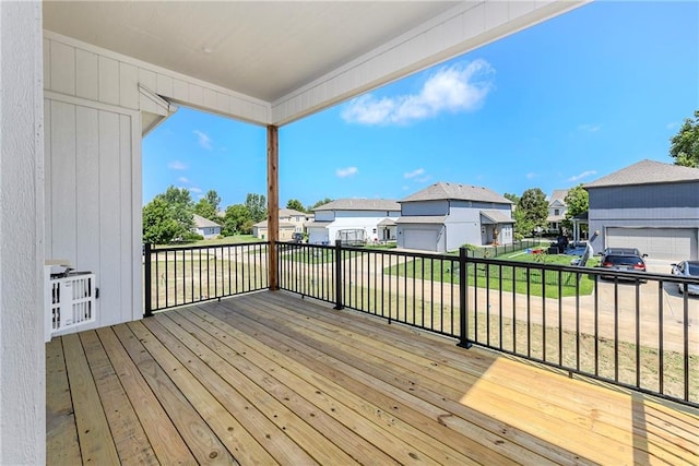 deck with a residential view and a lawn