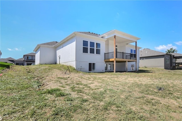 rear view of property with a lawn