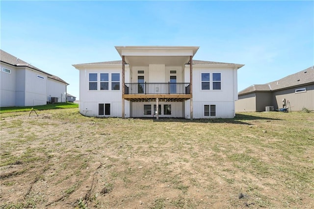 back of house featuring a deck, a yard, and central AC unit