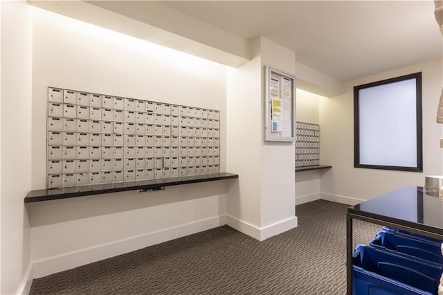 interior space featuring mail boxes and dark colored carpet