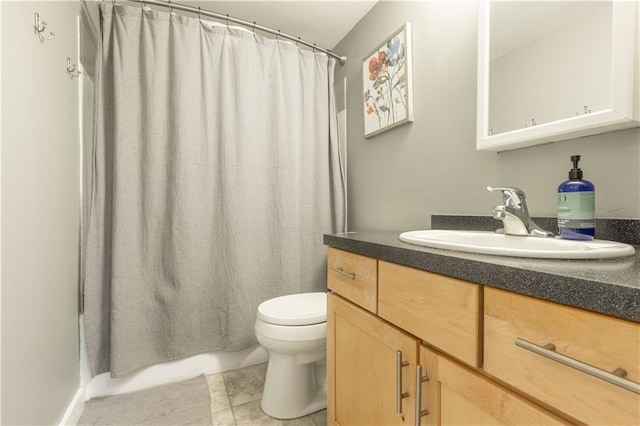 bathroom featuring vanity, toilet, and tile floors