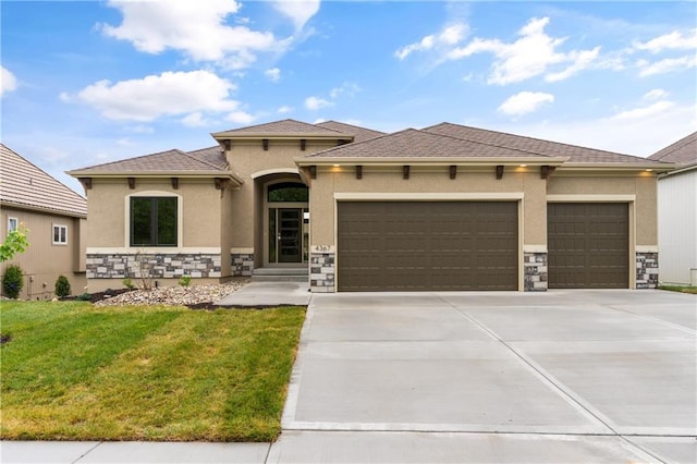 prairie-style home with a garage and a front yard