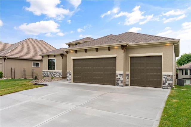 prairie-style home featuring a garage and central AC